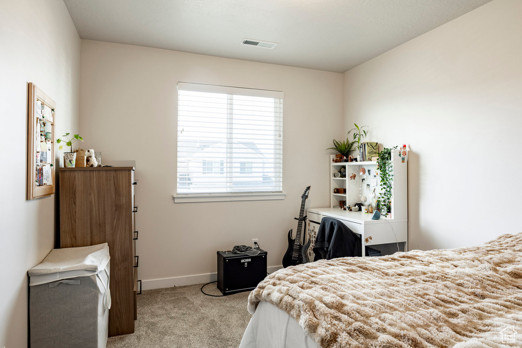 Bedroom with carpet flooring and baseboards