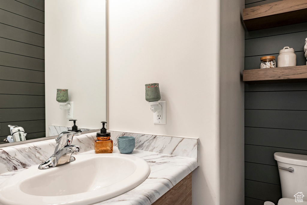 Half bathroom with toilet and vanity