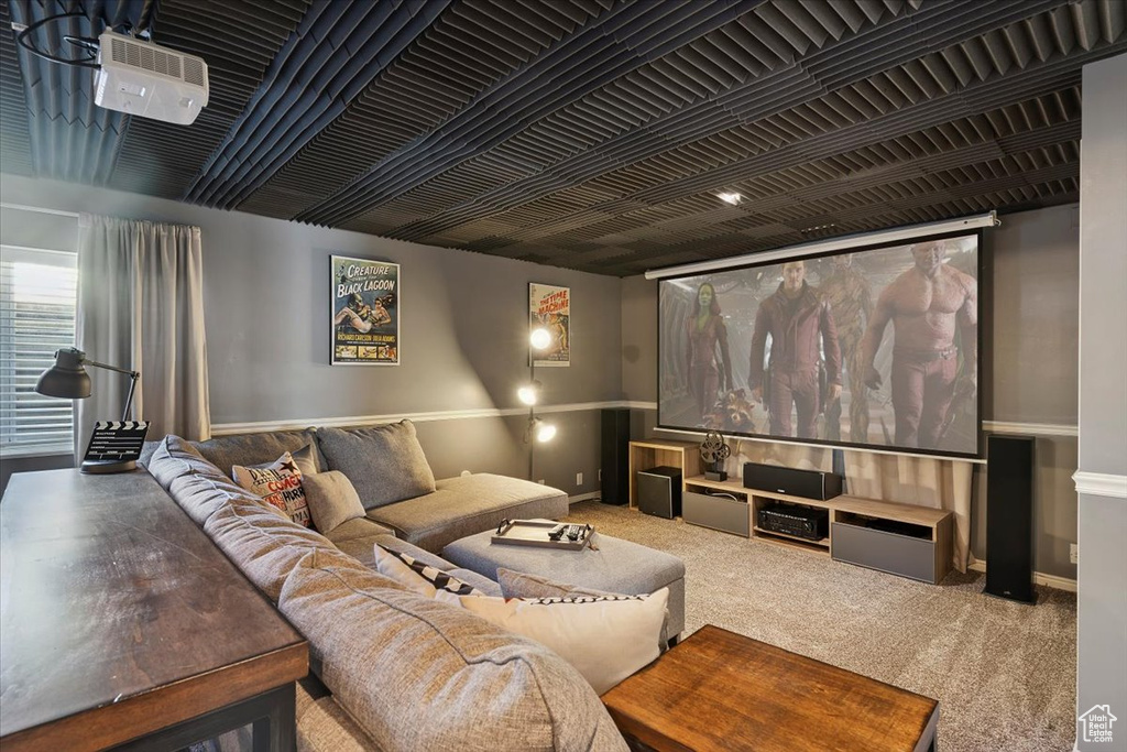 Carpeted cinema room with baseboards