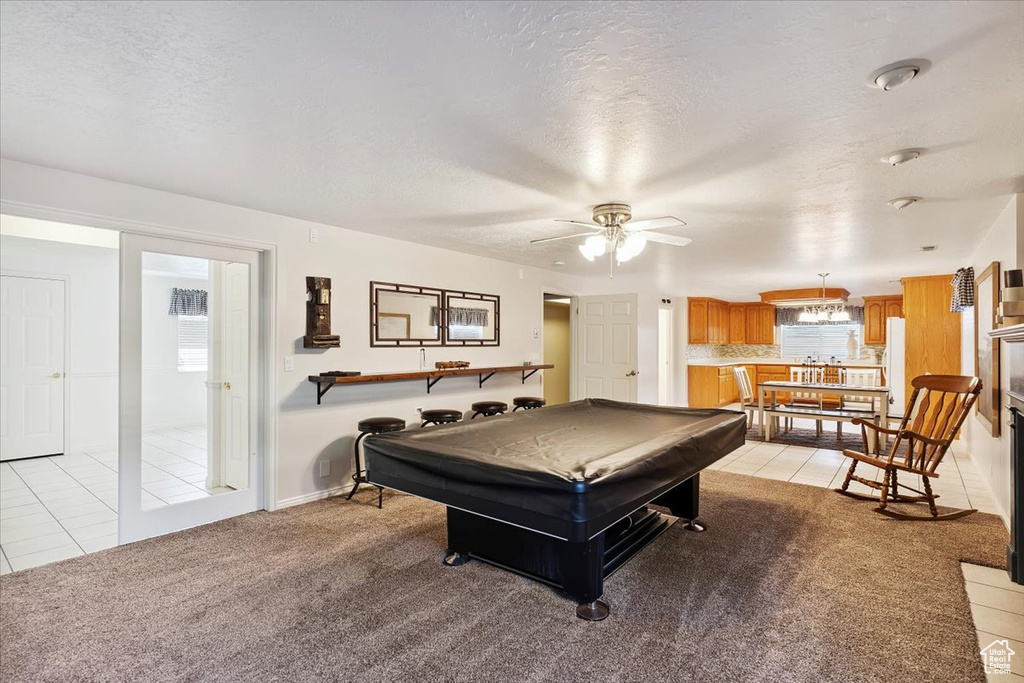 Playroom featuring billiards, light tile patterned flooring, a ceiling fan, a textured ceiling, and light colored carpet