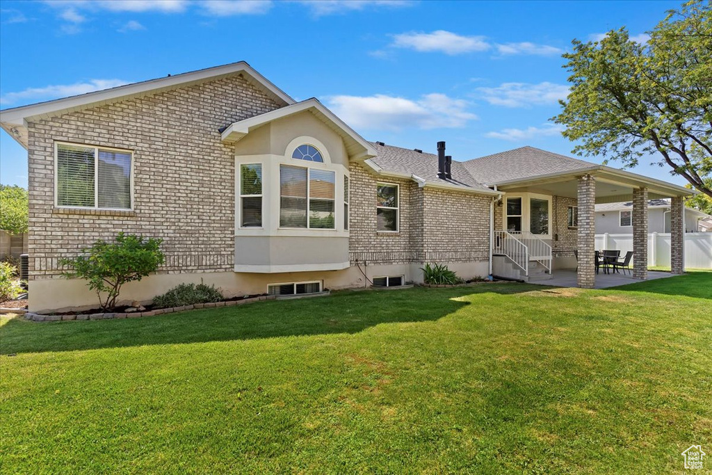 Back of property featuring a patio area and brick siding