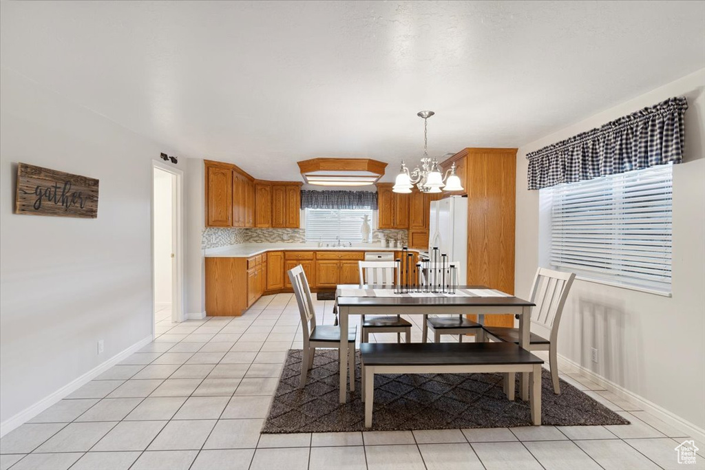 Dining space with a chandelier and light tile patterned floors