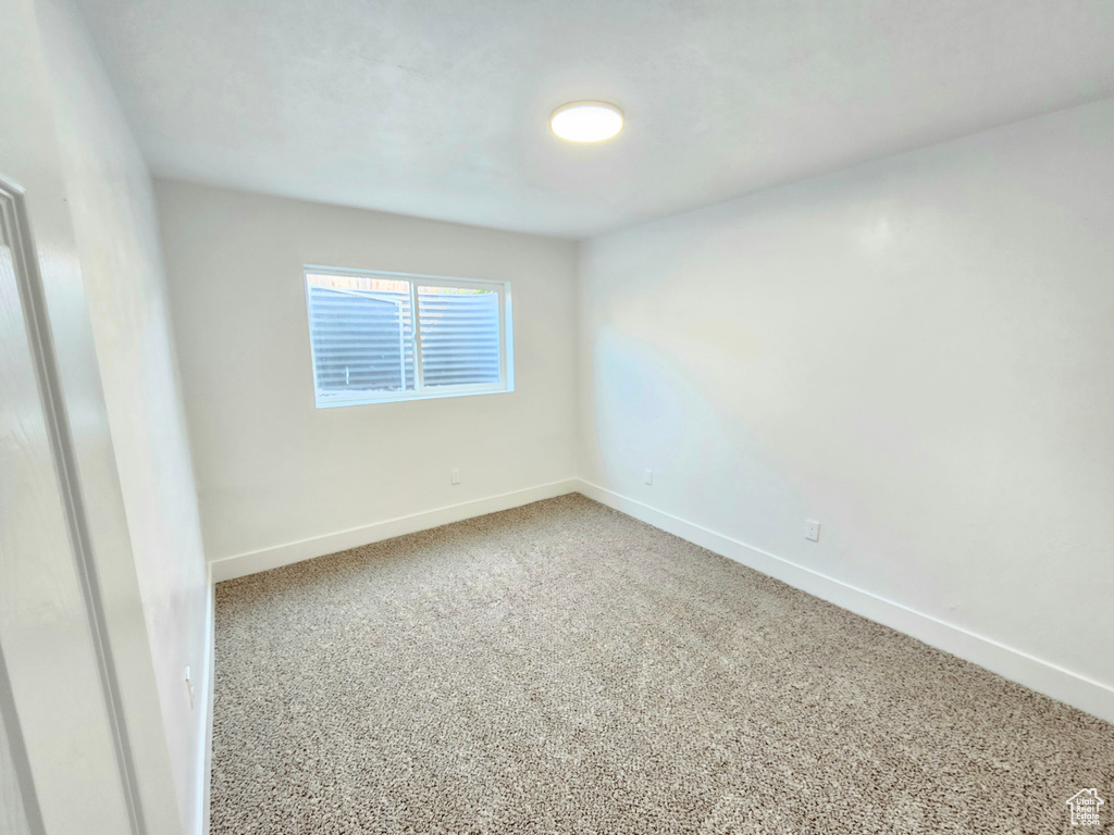 Unfurnished room featuring baseboards and carpet