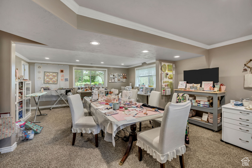Dining room featuring ornamental molding, light colored carpet, and recessed lighting
