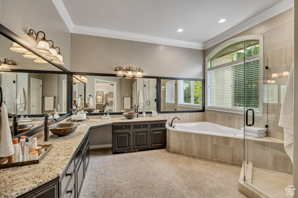 Full bathroom with a stall shower, vanity, a bath, ornamental molding, and recessed lighting