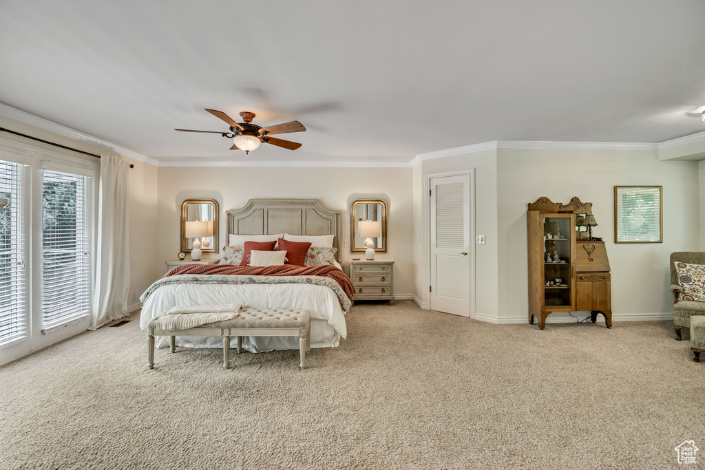 Bedroom with ornamental molding, carpet flooring, ceiling fan, and access to outside