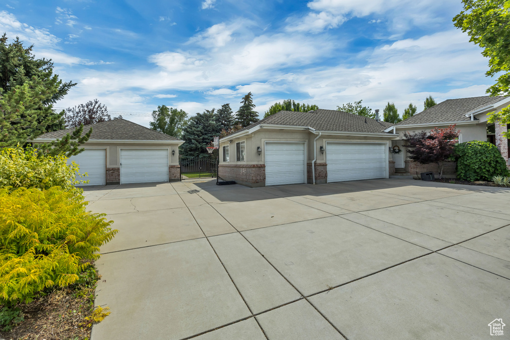 View of side of home with an outdoor structure and brick siding