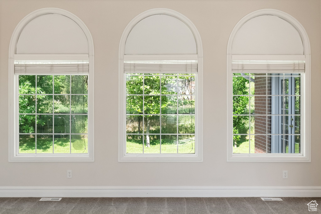 Detailed view of carpet flooring and baseboards