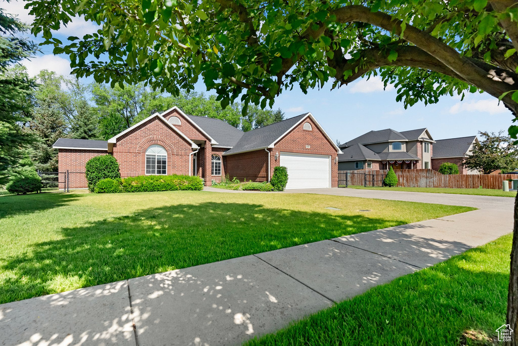Traditional-style house with brick siding and concrete driveway