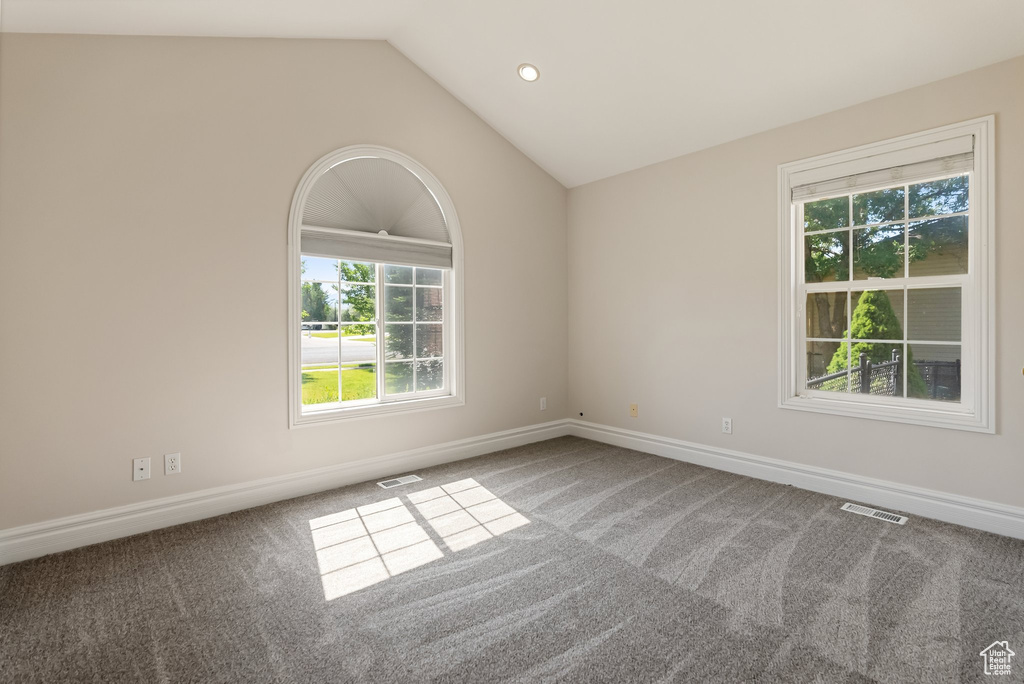 Unfurnished room featuring carpet, vaulted ceiling, and recessed lighting