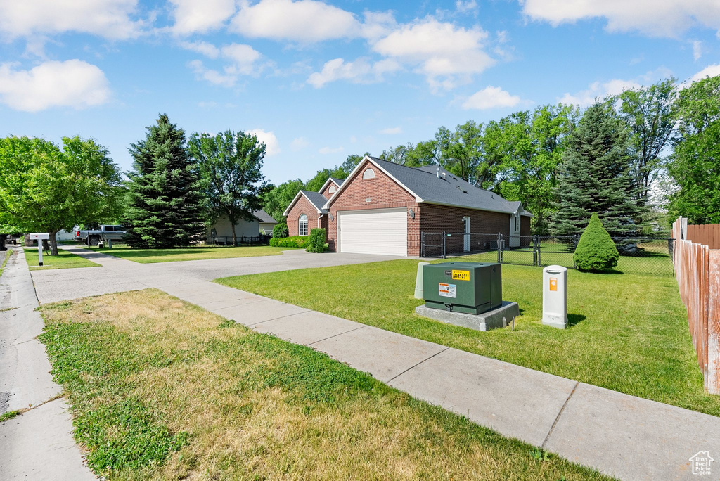 View of home\\\'s exterior with brick siding, driveway, and a garage