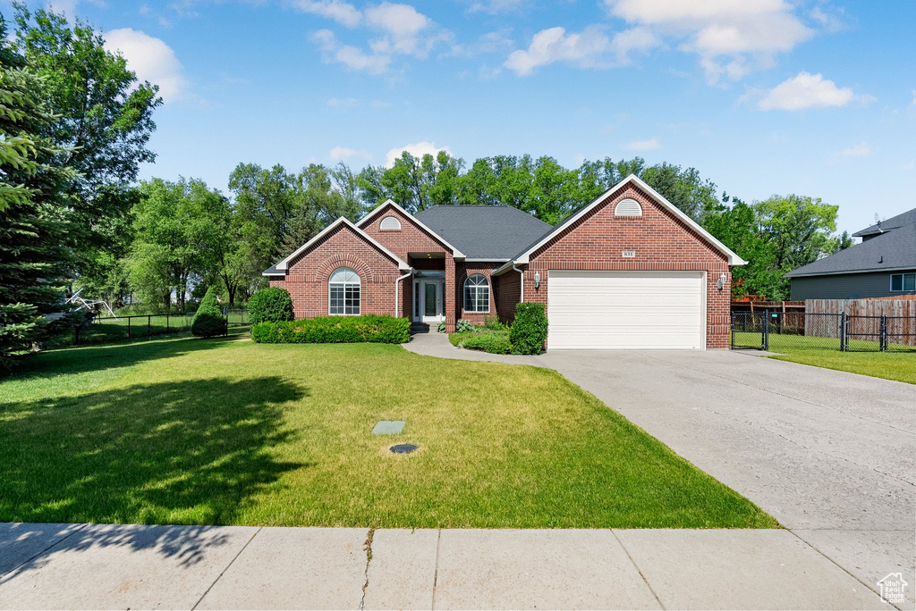 View of front facade featuring brick siding, an attached garage, and concrete driveway