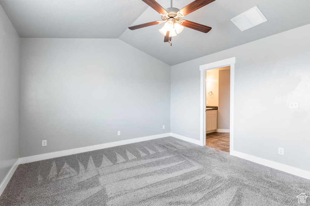 Unfurnished room with carpet floors, a ceiling fan, and lofted ceiling