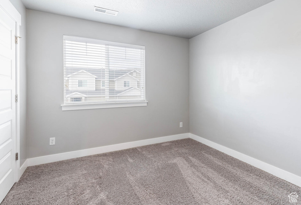 Spare room with carpet floors and baseboards