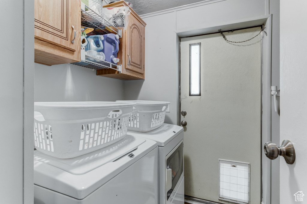 Laundry room with cabinet space and washing machine and clothes dryer