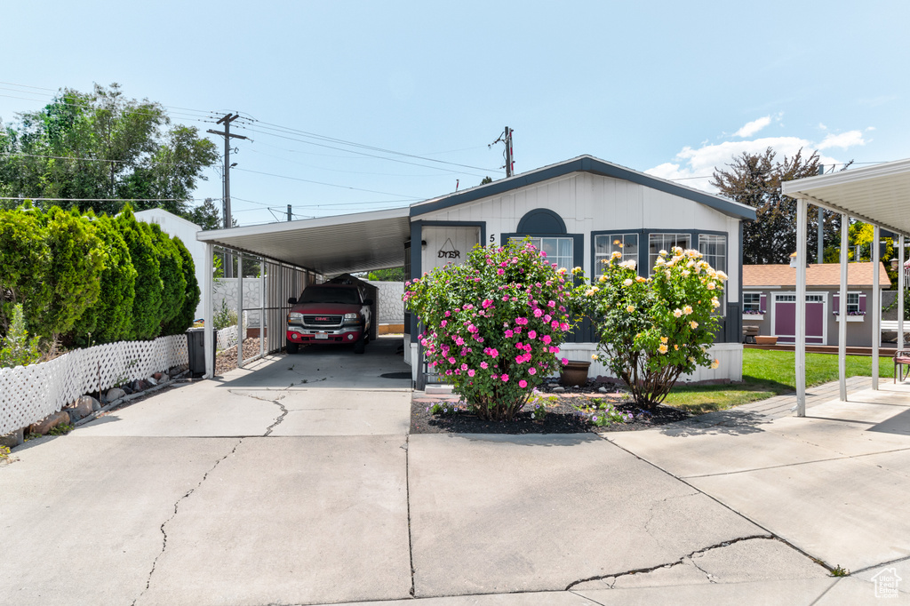 Manufactured / mobile home featuring driveway and an attached carport