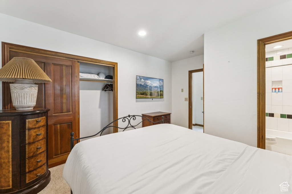 Bedroom with a closet, connected bathroom, and recessed lighting