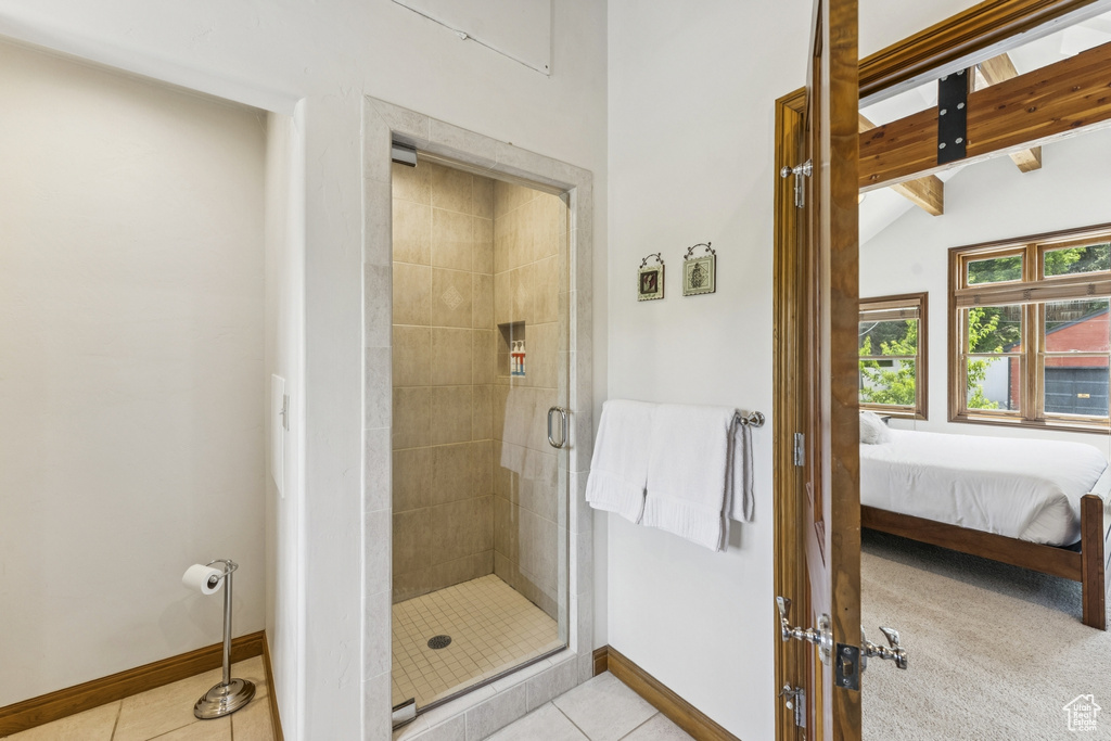 Bathroom with a stall shower, connected bathroom, and tile patterned floors