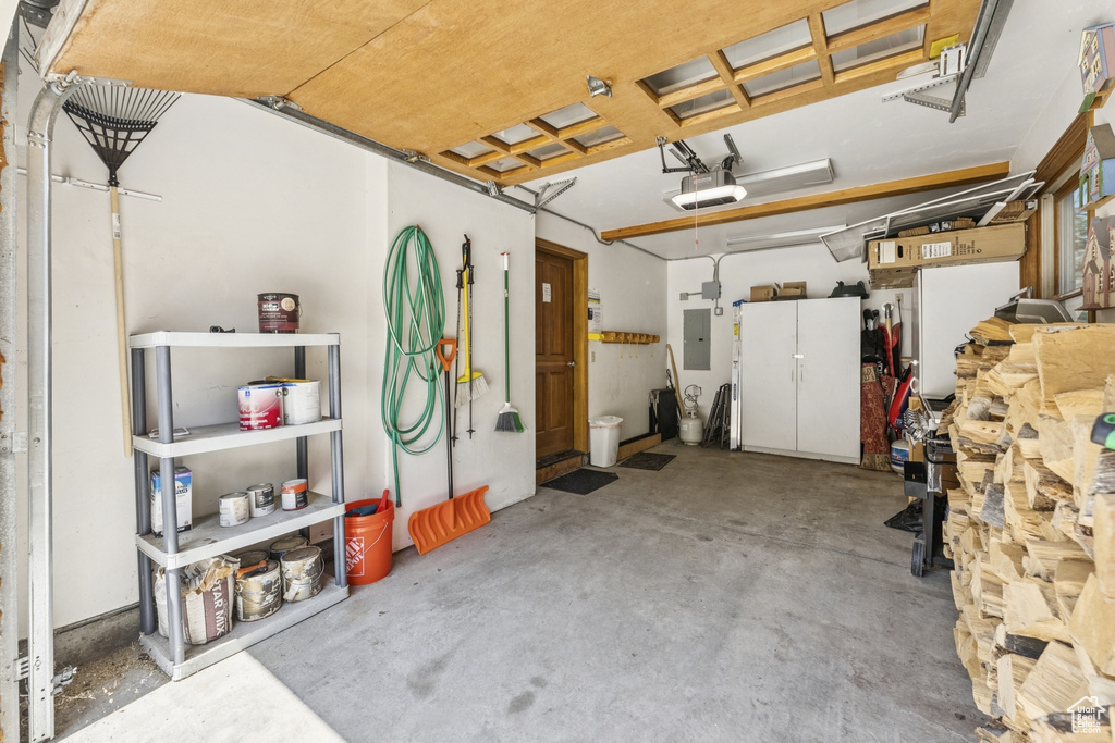 Garage with electric panel and a garage door opener