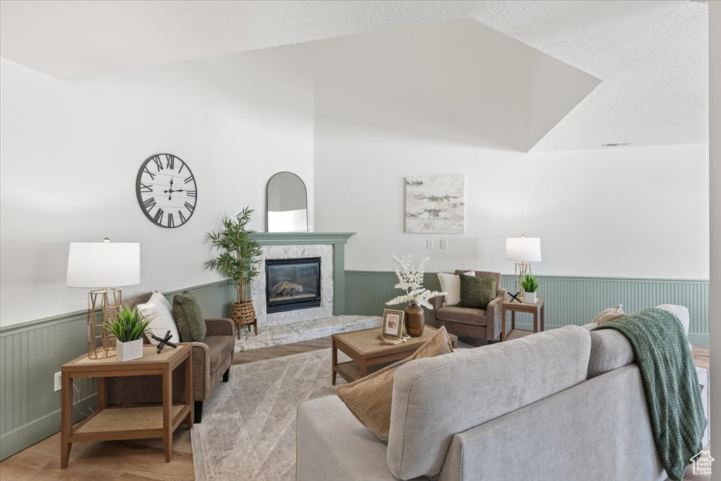 Living area with a wainscoted wall and a premium fireplace