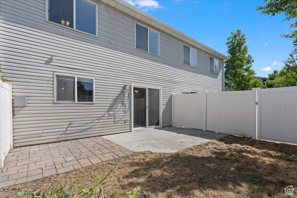 Back of house featuring a patio area and a gate