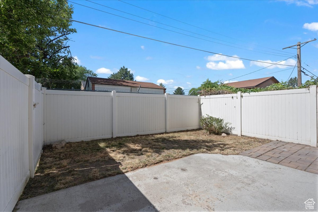 Fenced backyard featuring a patio
