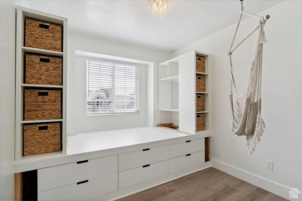 Mudroom with wood finished floors and a textured ceiling