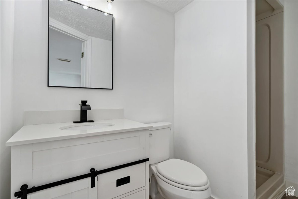 Full bath with vanity and a shower