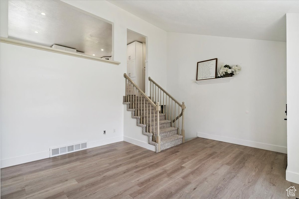 Foyer with wood finished floors and stairs