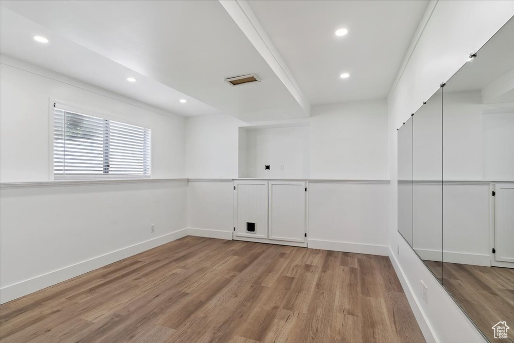 Empty room featuring wood finished floors and recessed lighting