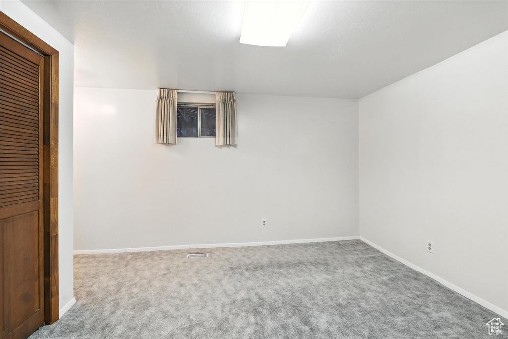 Unfurnished bedroom with carpet and baseboards