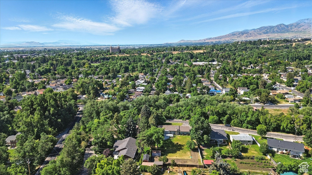 Aerial overview of property's location with a mountain backdrop and nearby suburban area