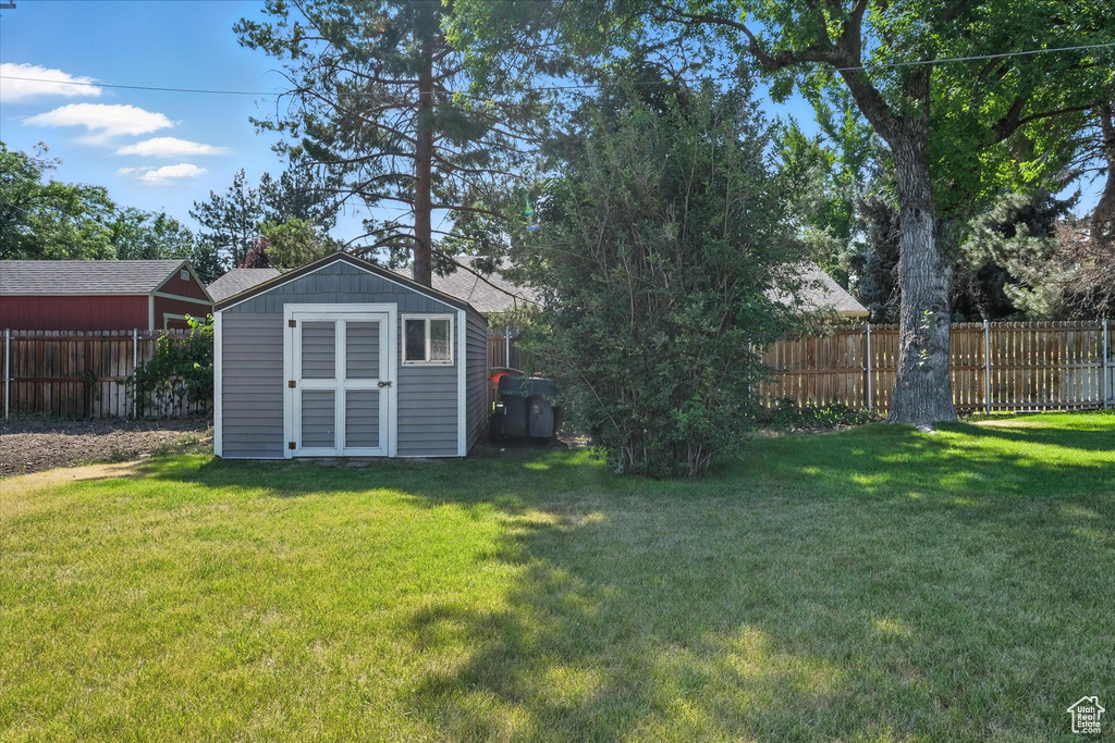 Fenced backyard with a storage shed