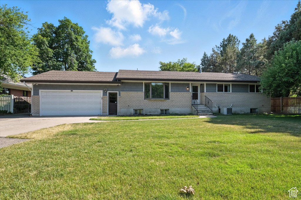 Ranch-style house with concrete driveway, a garage, and brick siding