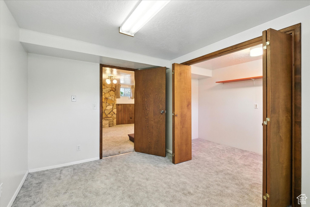 Spare room with carpet floors and a textured ceiling