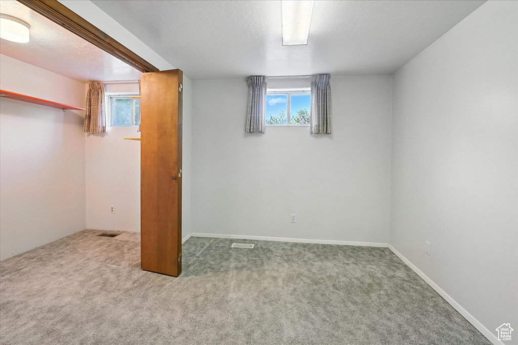 Below grade area featuring carpet and plenty of natural light