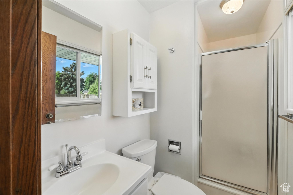 Bathroom featuring a shower stall and vanity