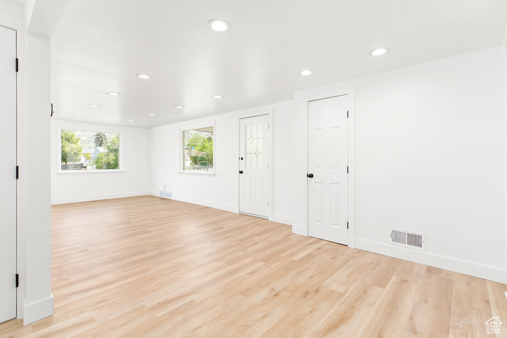 Spare room with light wood-style floors and recessed lighting