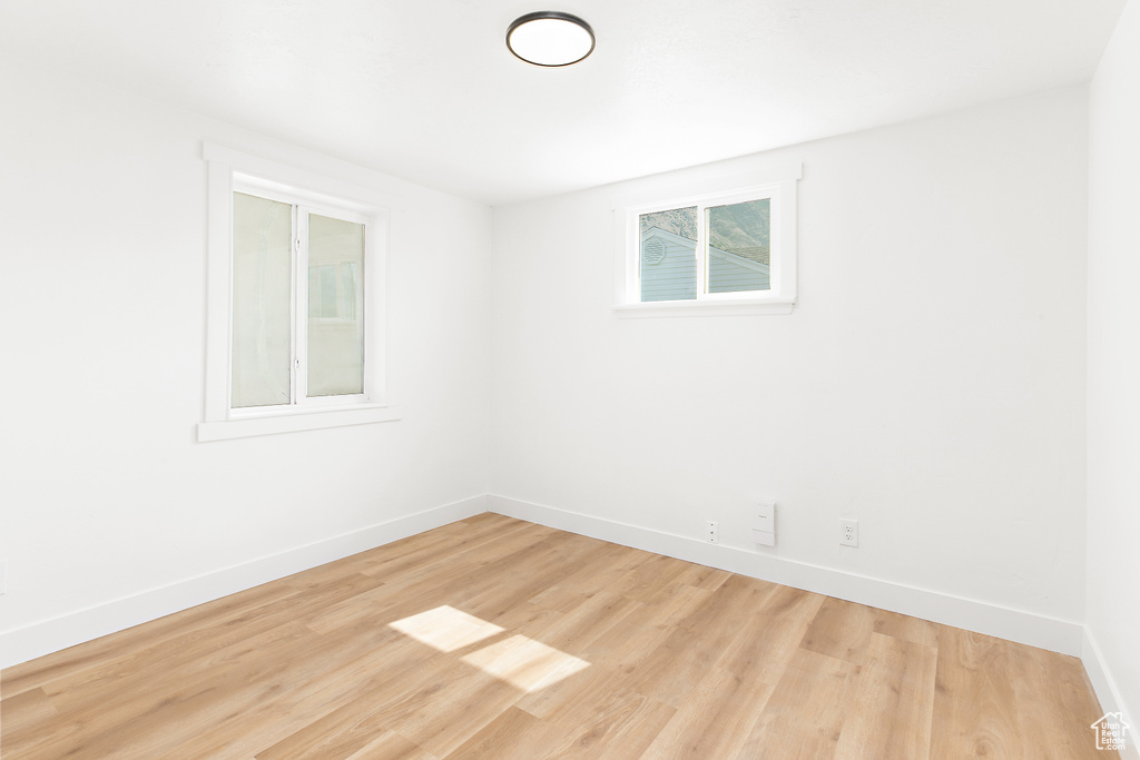 Unfurnished room featuring baseboards and wood finished floors