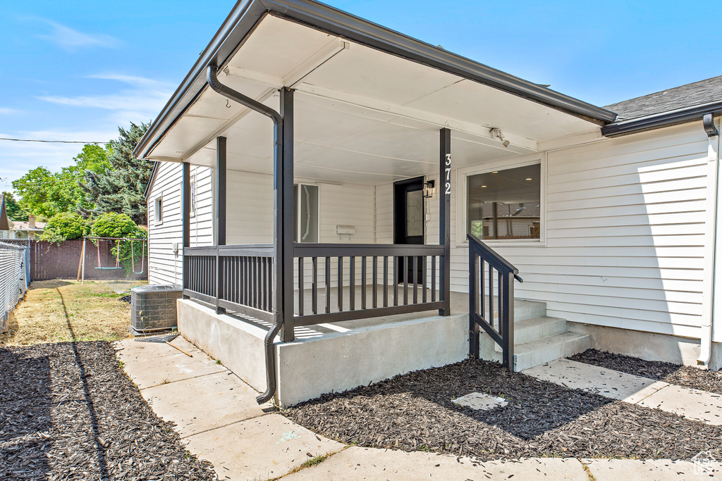 Entrance to property featuring covered porch