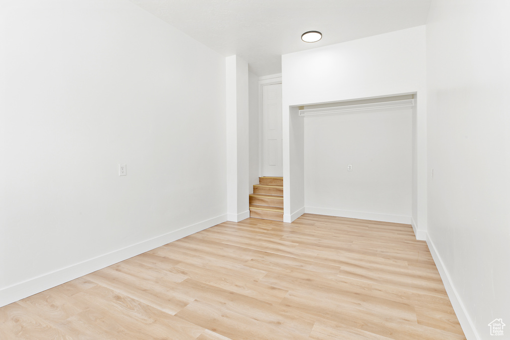 Unfurnished room featuring light wood-style flooring and baseboards
