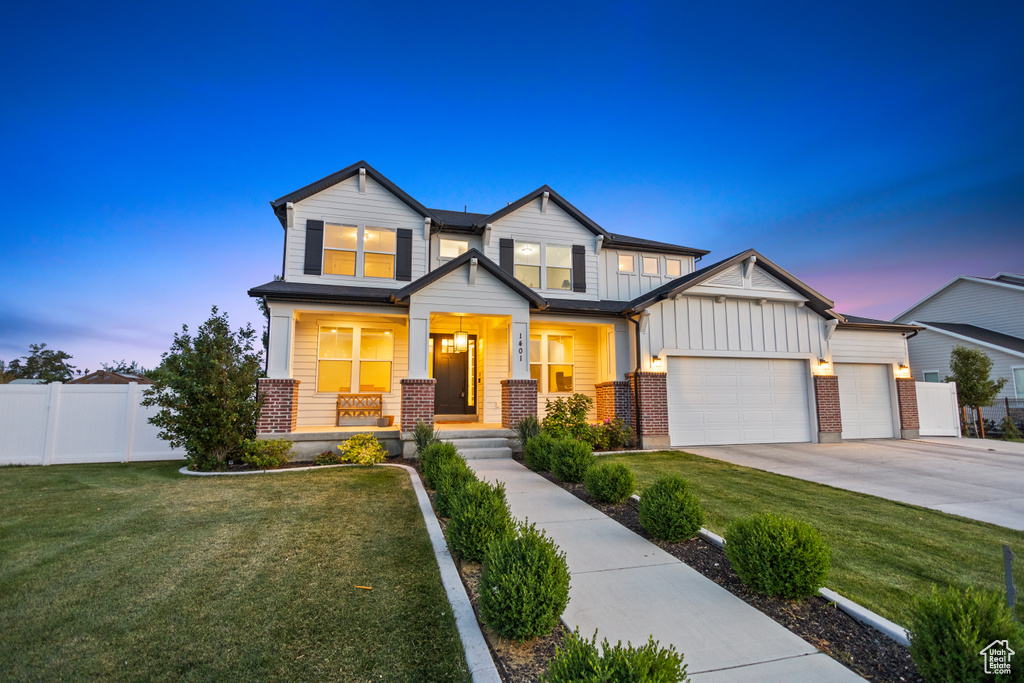 Craftsman inspired home with brick siding, board and batten siding, a porch, an attached garage, and driveway