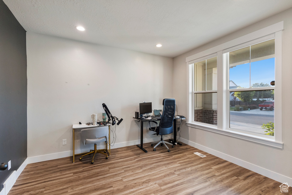 Office area with wood finished floors and recessed lighting