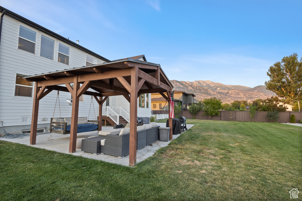 View of yard featuring an outdoor hangout area, a mountain view, a gazebo, and a patio