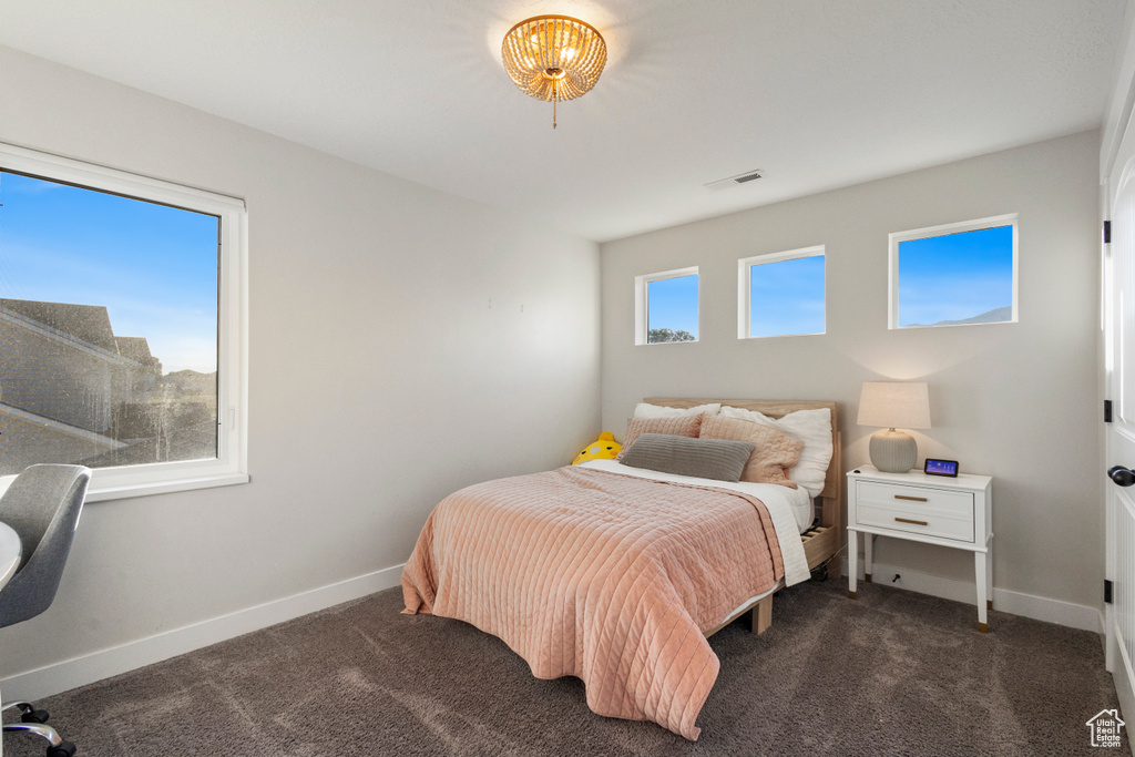 Carpeted bedroom featuring baseboards