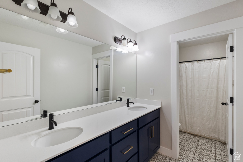 Full bath with double vanity and toilet