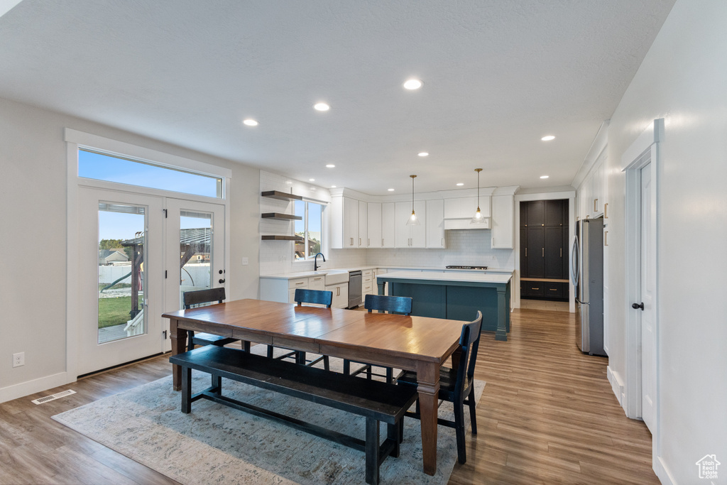Dining space featuring wood finished floors and recessed lighting