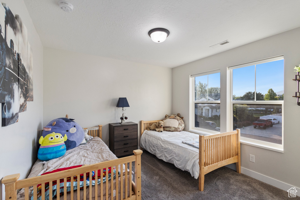 Carpeted bedroom featuring baseboards