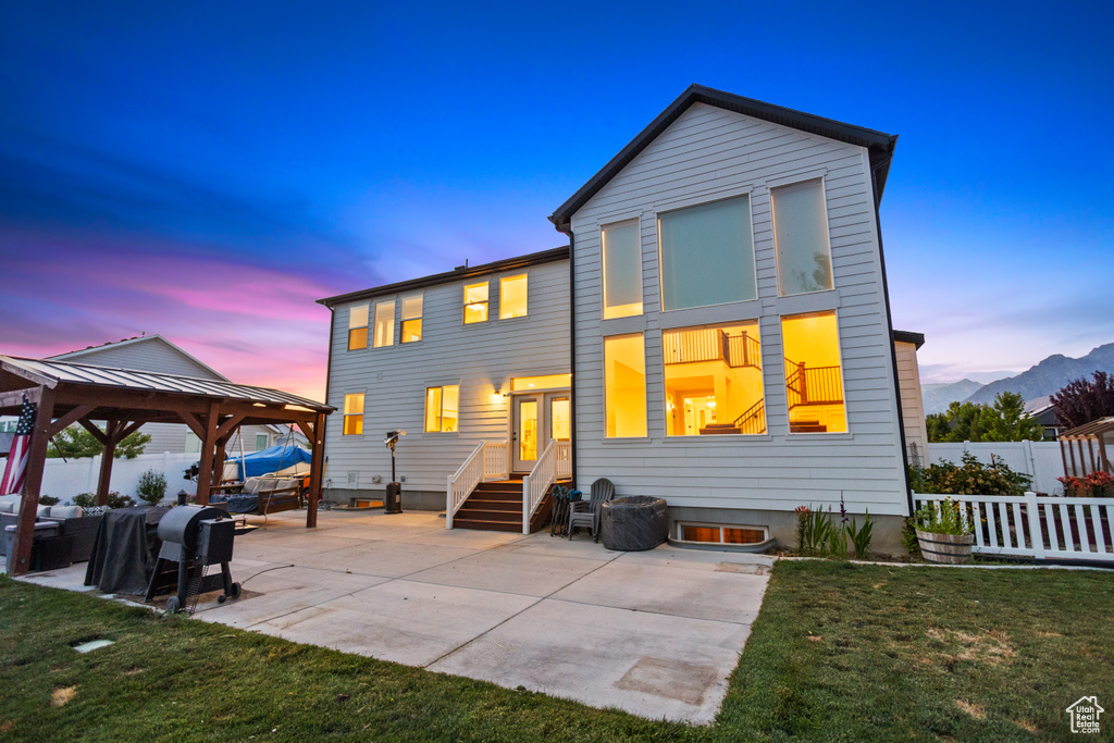 Back of house with a gazebo, a patio area, outdoor lounge area, a mountain view, and entry steps