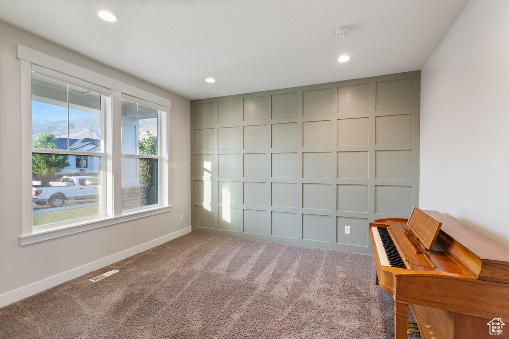 Unfurnished room with a smoke detector, recessed lighting, and carpet flooring